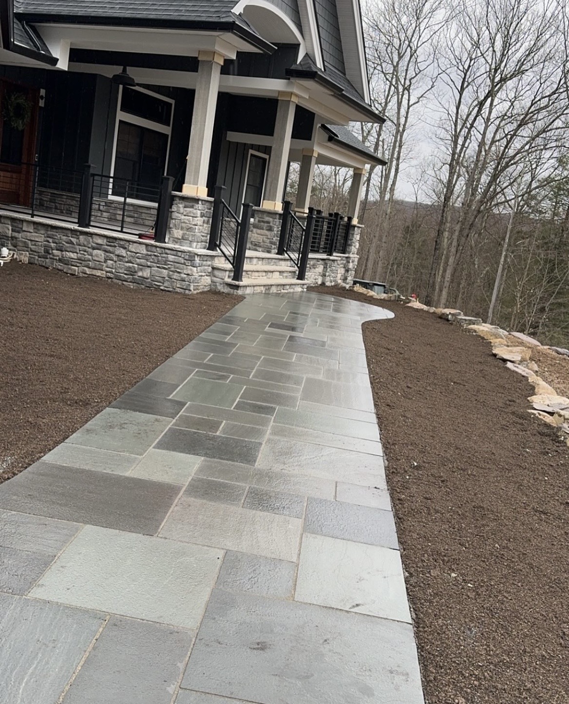 Bluestone walkway leading to a high-end home