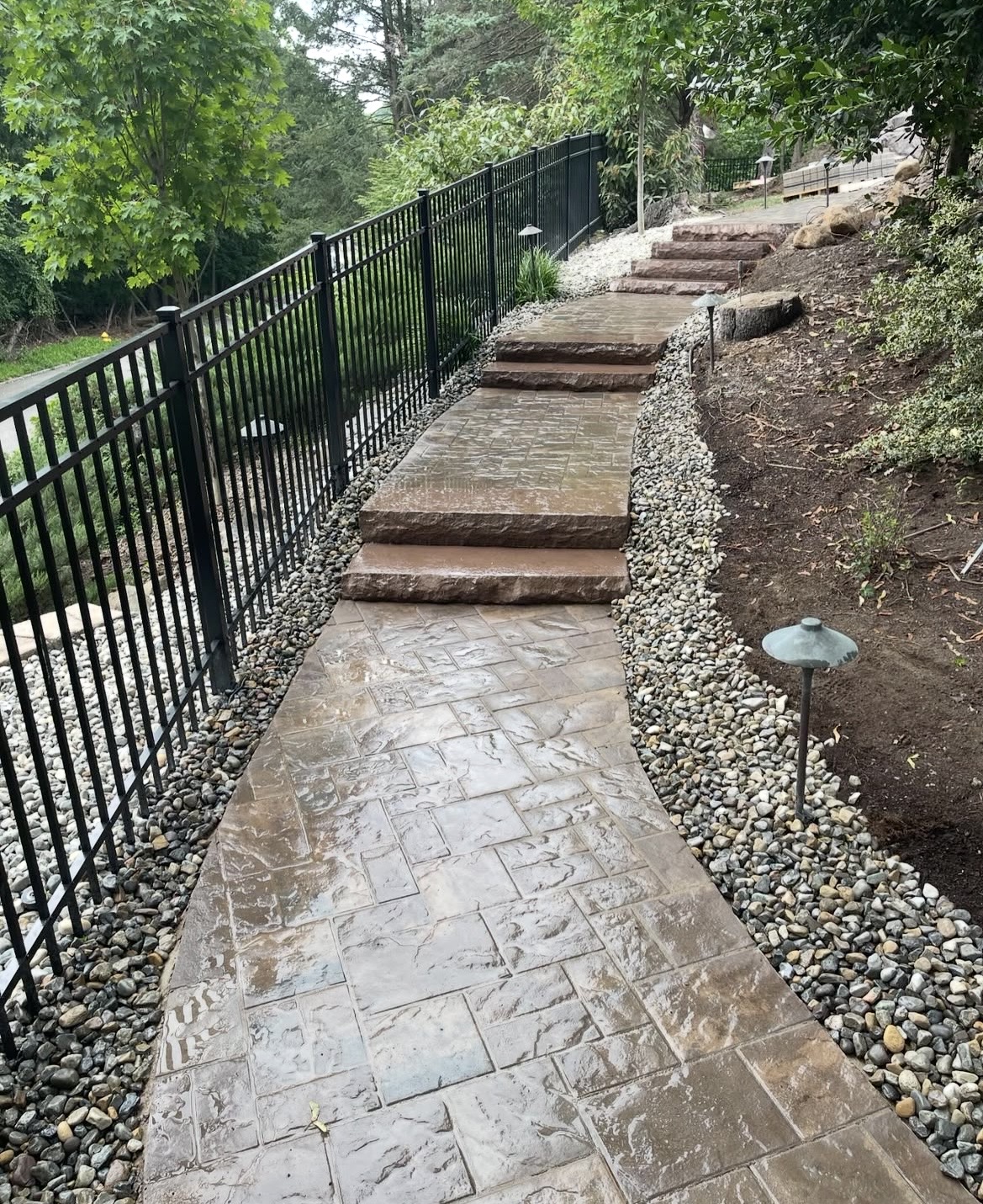 Stamped stone walkway with steps and landscape lighting